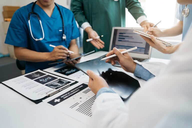 Medical team working on digital tablet healthcare doctor technology tablet using computer analyzed the results of medical reports at the hospital.