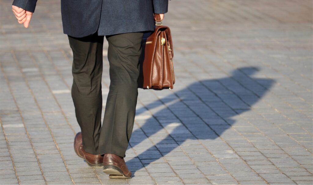 male business professional walking with briefcase