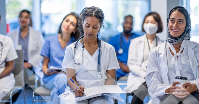 Group of locum tenens and permanent physicians attending hospital staffing trends 2026 meeting